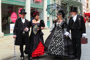  Wave Gothic Meeting, May 2015, Leipzig, Almanya: Geleneksel gotik giysiler içinde iki yetişkin şehir merkezinde bir sokakta konuşuyor