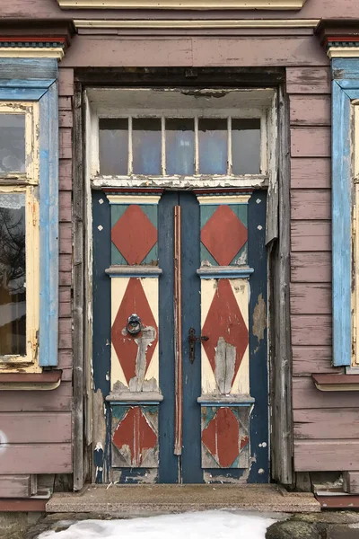 Vintage color entry door in aged wooden house in Germany. Clausthal-Zellerfeld, Harz mountains.