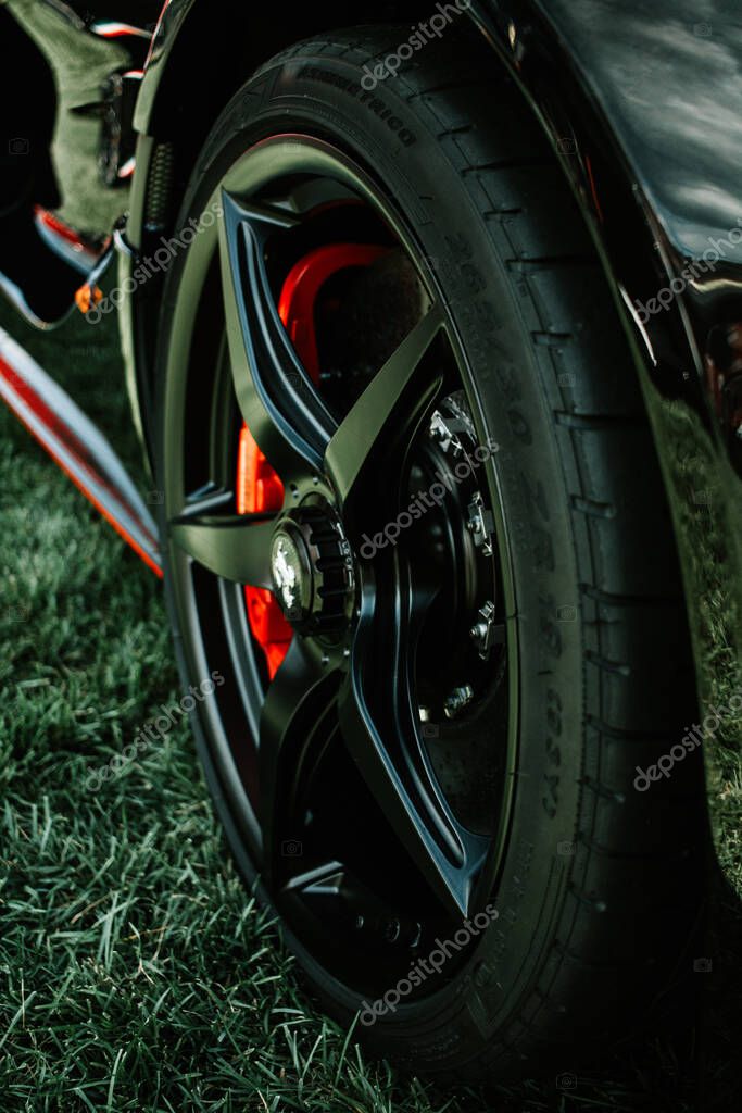 The Farmington Polo Grounds, Farmington, CT USA - August 22, 2020: Side wheel view of Black Ferrari Race Car. The Dream Ride Club.