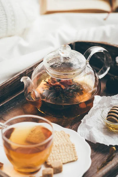 Warming tea in bed. Window light
