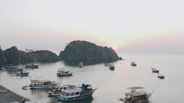 Nascer do sol ou pôr do sol a partir de montanhas no oceano, paisagem natural, céu rosa, barcos de pesca e navios turísticos, iates no mar, vista do drone, panorâmica do ar, à noite ou de manhã vista da baía na Turquia. — Vídeo de Stock