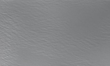 Tek renkli doku arka planı. Görüntü siyah ve beyaz tonları içerir. Yüzey sert görünüyor. Gri yazdırma ögesi.