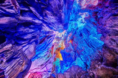 Ceiling of the Reed Flute Cave, natural limestone cave with multicolored lighting in Guilin, Guangxi, China. clipart