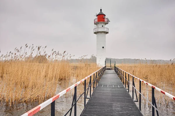 Inland waterway lighthouse seen from a steel pier — Stock Photo, Image