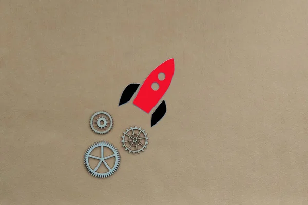 Rocket Going Wooden Gears Light Brown Background Aspiration Anticipation Leadership — Stock Photo, Image