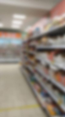 Rafların arka planı bulanık ve süpermarketin içindeki mallar. Satış, satış pazarı.