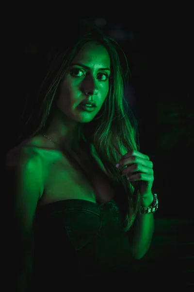 黒の結晶に反映緑の鉛の光によって照らされた黒のドレスで白人ブルネット 都市の夜の写真 女の子かむサングラス — ストック写真