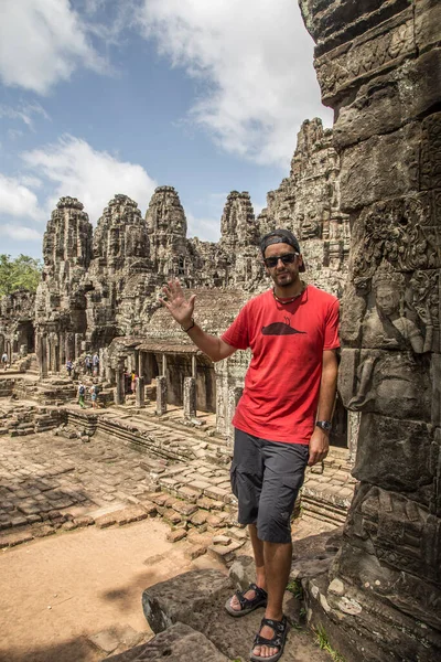 man in front of ancient ruins of Angkor Wat, Siem Reap, Cambodia