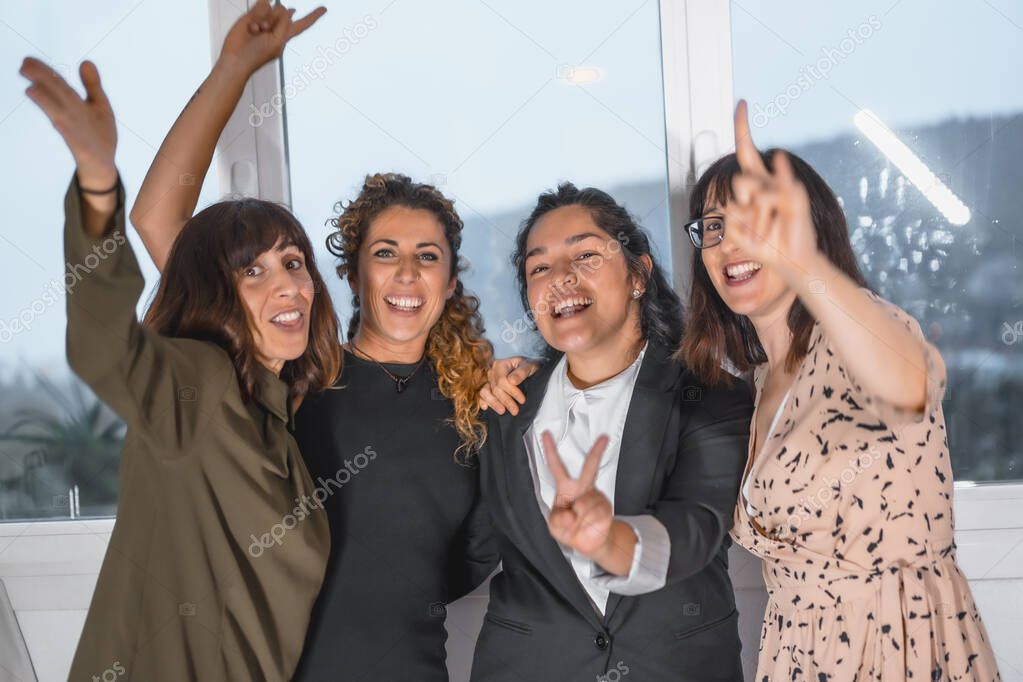 four female colleagues having fun in office 