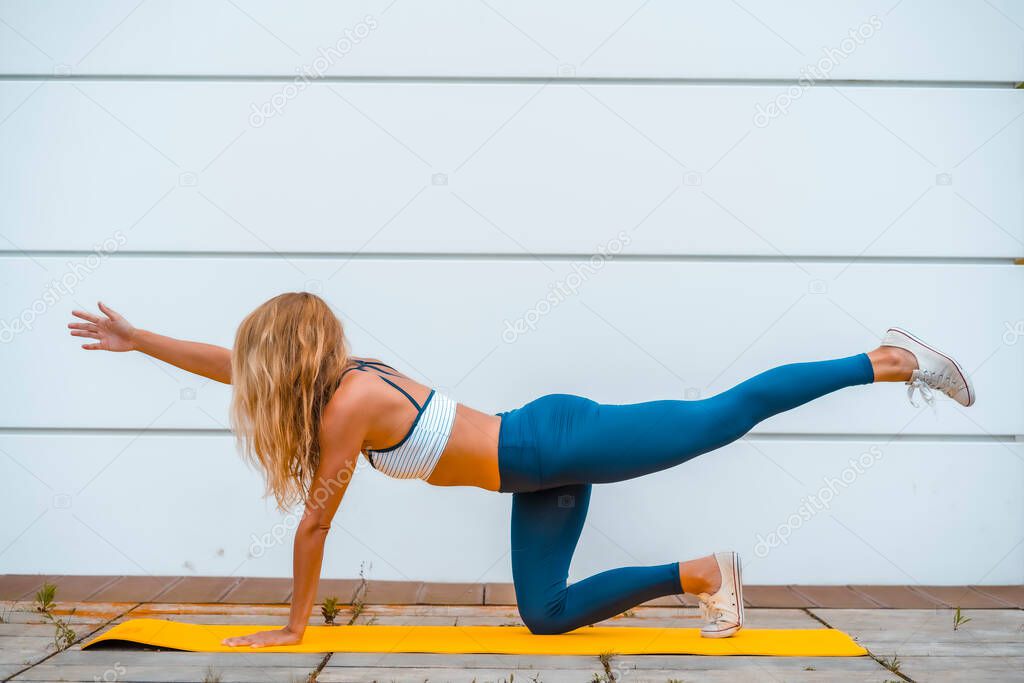 fit blonde woman doing yoga 