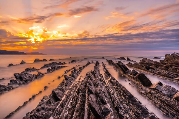Beautiful sunset of the Geopark called Flysch on the Sakoneta beach in the town of Deba, Geopark of the Basque Coast, Guipzcoa. Basque Country.