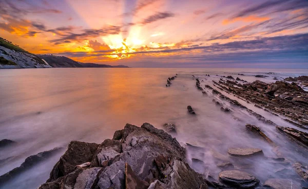 Stones at sunset of the Geopark called Flysch on the beach of Sakoneta in the town of Deba, at the western end of the Geopark of the Basque Coast, Guipzcoa. Basque Country