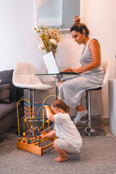 Young Caucasian Mother Caring Her Young Son Teleworking Home Closed — Stock Photo, Image