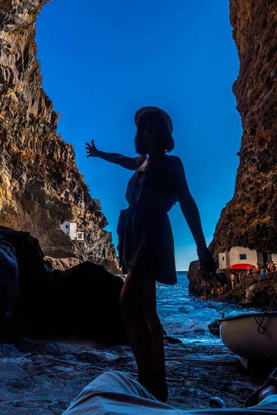 A young woman inside the cave of the town of Poris de Candelaria on the north-west coast of the island of La Palma, Canary Islands. Spain.