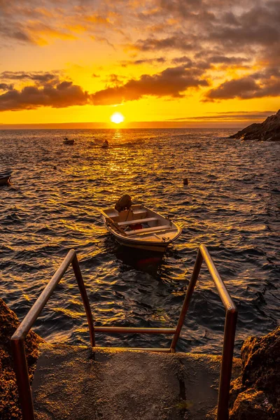 Sunset next to a staircase that goes down to the sea in the town of Poris de Candelaria on the north-west coast of the island of La Palma, Canary Islands. Spain