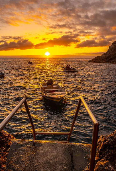 Sunset next to a staircase that goes down to the sea in the town of Poris de Candelaria on the north-west coast of the island of La Palma, Canary Islands. Spain