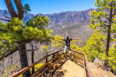 Kanarya Adaları 'ndaki Caldera de Taburiente' nin yanındaki La Palma adasındaki Mirador Lomo de las Chozas de La Cumbrecita 'da genç bir turist. İspanya