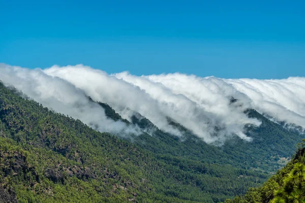 Clouds cross the mountains from side to side on the island of La Palma, Canary Islands. Spain