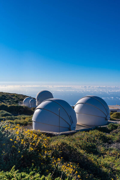 Observatories of the Roque de los Muchachos in the Caldera de Taburiente with a sea of nuts below one summer afternoon, La Palma, Canary Islands. Spain