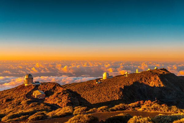 Observatories of Roque de los Muchachos in the Caldera de Taburiente in a beautiful orange sunset, La Palma, Canary Islands. Spain