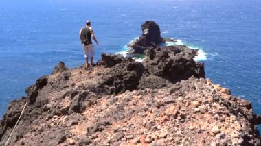 Genç bir turist, Kanarya Adaları 'ndaki La Palma adasının kuzeyindeki Bujaren' ın kara kumlu plajına iniyor. İspanya