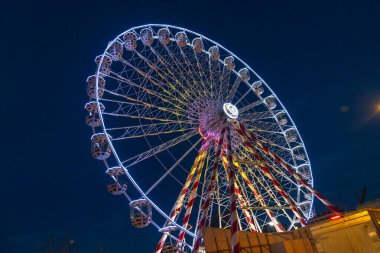 Dönme dolap gece gökyüzünü aydınlatıyor. Süngü, Fransa 'da şenlikli ve büyülü bir atmosfer yaratıyor.