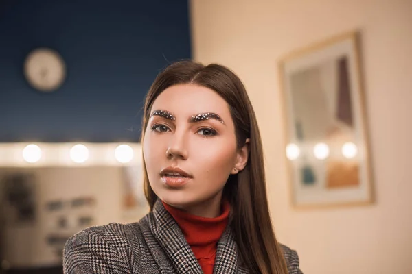 Portrait of a beautiful girl with laminated eyebrows