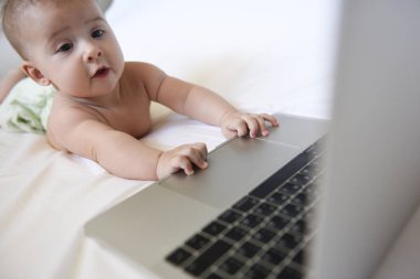 Bir dizüstü bilgisayarda yaramazlık biniyorlar iken bir bebek kızlar yüzündeki sürpriz ifade