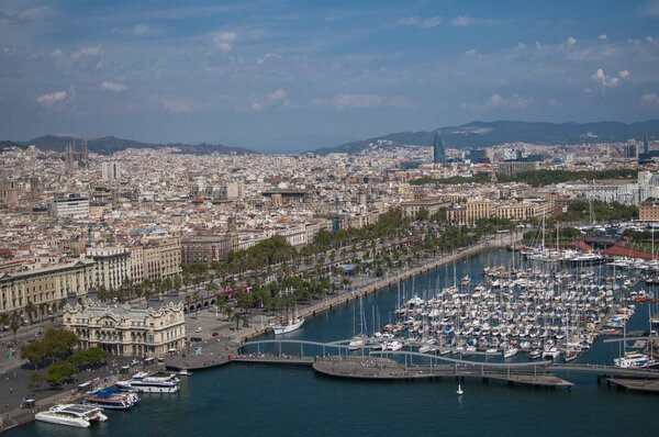 BARCELONA, SPAIN - SEPTEMBER 9, 2014: Aerial view of Barcelona from the cableway to the Montjuic hill with the Barceloneta beach and Port Vell. Catalonia, Spain, Europe