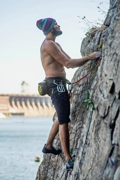 Man climber climbing up the rock. Active lifestyle, extreme sport.