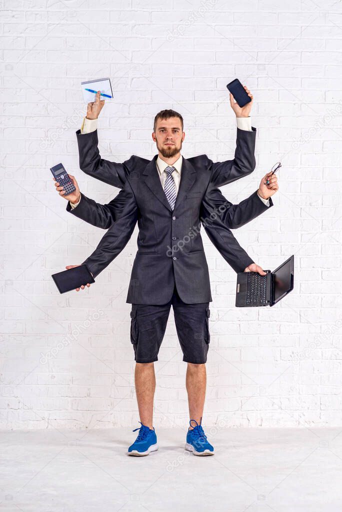 A man with many hands is standing in a jacket and shorts. Multitasking. Business man, workaholic.