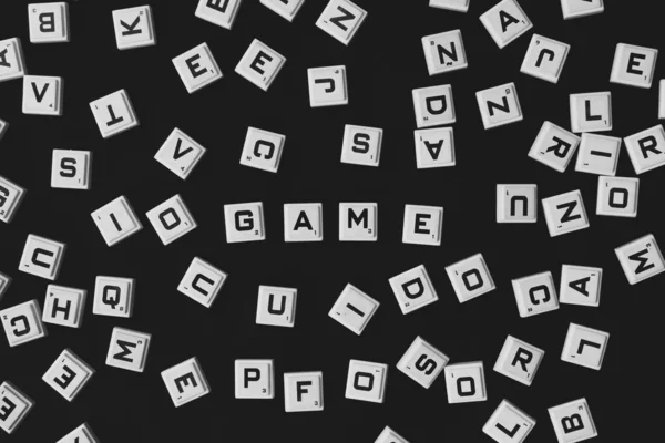 Game word presented. Word game. Highlighted.. Black and white background. Stand out from the rest. Top view.