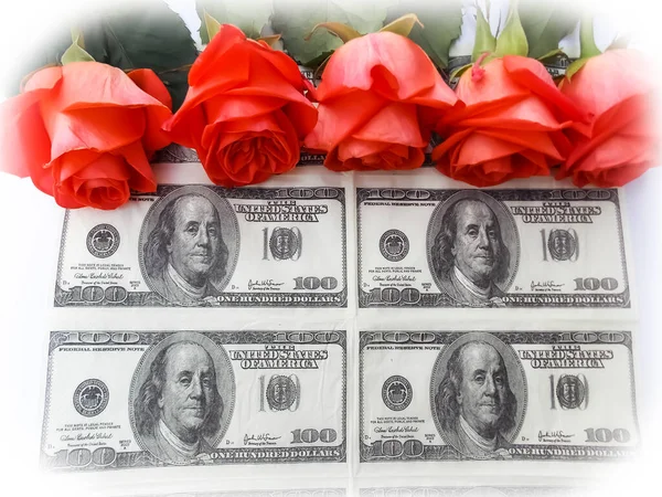 red roses and money on a white background