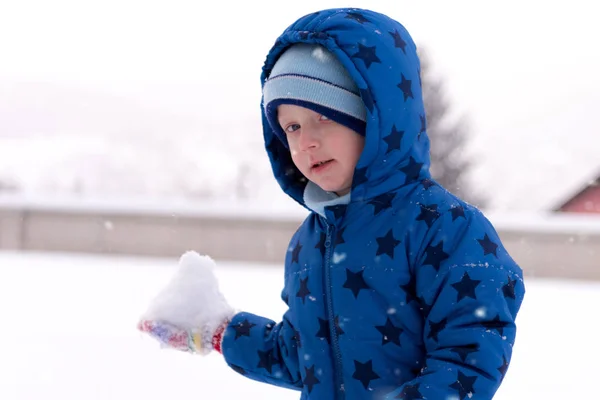 Child, three years old boy in winter clothes playing with snow. — Stock Photo, Image