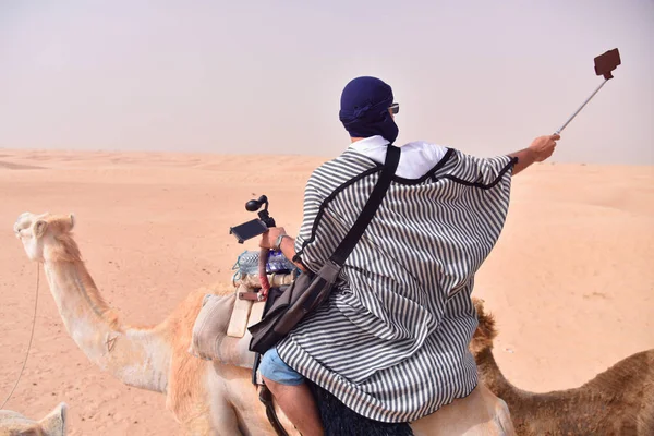 Camels caravan going in sahara desert in Tunisia, Africa. Touris