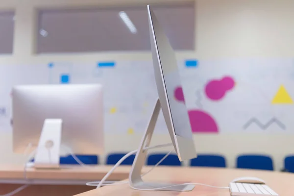 Modern office with computers on desks. Empty computer room in co — Stock Photo, Image