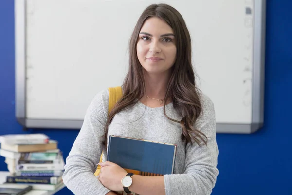 Portrait of a young beautiful female student inside classroom. S — Stock Fotó