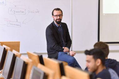 Bayan profesör öğrencilere açıkla ve onlarla iletişim kur.