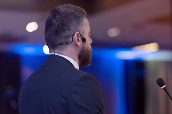 Young businessman at business conference room with public giving