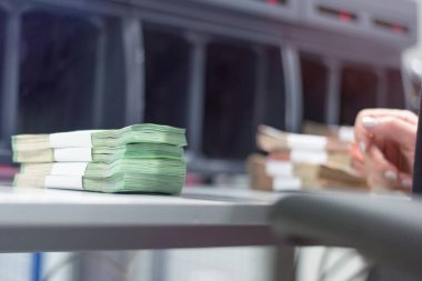 Banka çalışanları banka kasasında para sayıyor ve sıralıyor. Lar