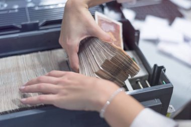 Banka çalışanları banka kasasında para sayıyor ve sıralıyor. Lar