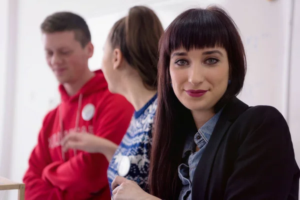 Female Architecture teacher looking and smiling into camera duri