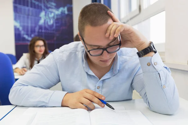 Youngmale student in math class overwhelmed by the math formula. — Stock Photo, Image