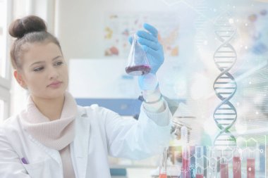 Laboratuvarda test tüpleriyle çalışan genç kadın laboratuvar bilim adamı.