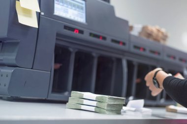 Banka çalışanları banka kasasında para sayıyor ve sıralıyor. Lar
