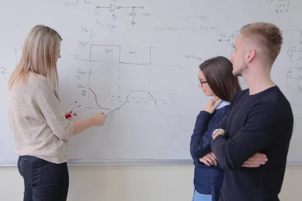 Two young college male and female students with young female tea