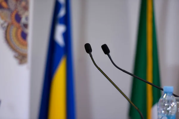 Microfones durante conferência de negócios em sala de conferências ou hal — Fotografia de Stock