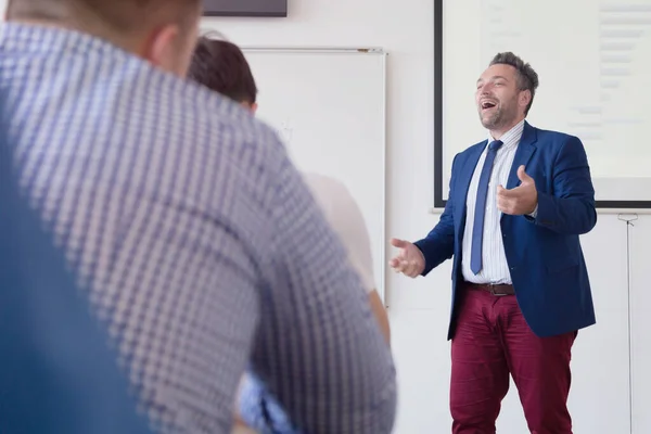 Mužský profesor vysvětlit lekci studentům a komunikovat s nimi — Stock fotografie