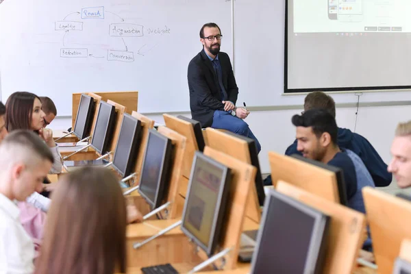 Чоловік-професор пояснює урок студентам і взаємодіє з ними — стокове фото