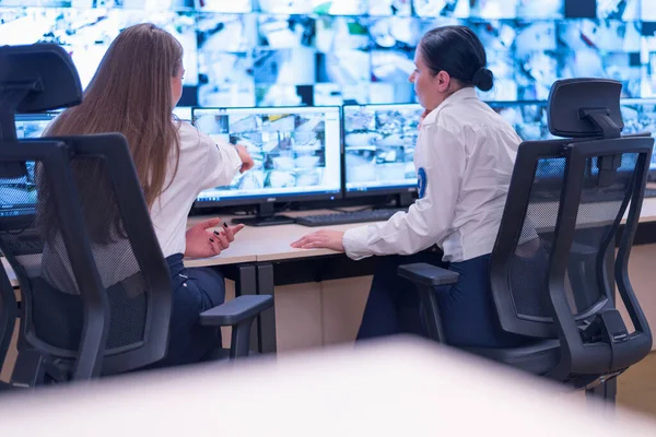 Security guard monitoring modern CCTV cameras in surveillance ro — Stock Photo, Image